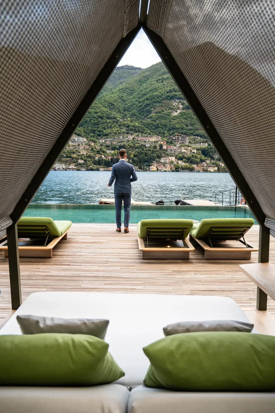 Man overlooking Lake Como from Il Sereno al Lago, a restaurant with stunning views.