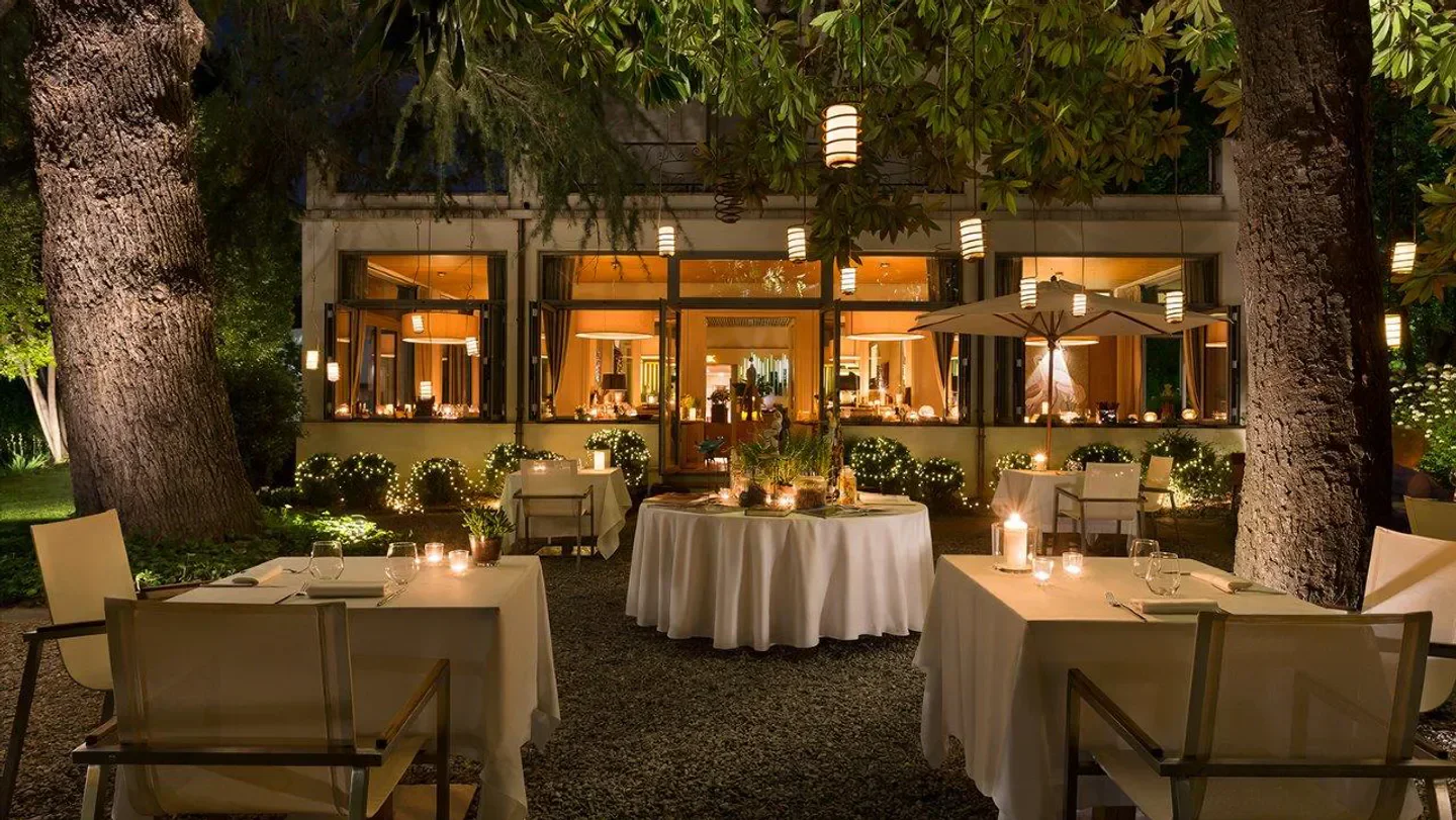 Outdoor dining at Kitchen restaurant in Lake Como, with candlelit tables and ambient lighting