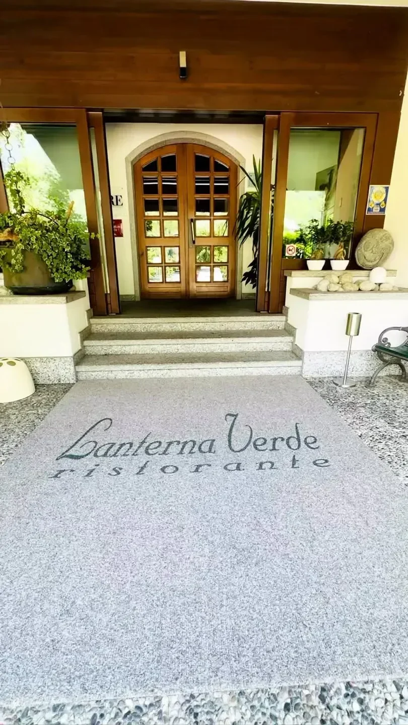 Entrance of Lanterna Verde restaurant in Lake Como, featuring a welcoming entrance.
