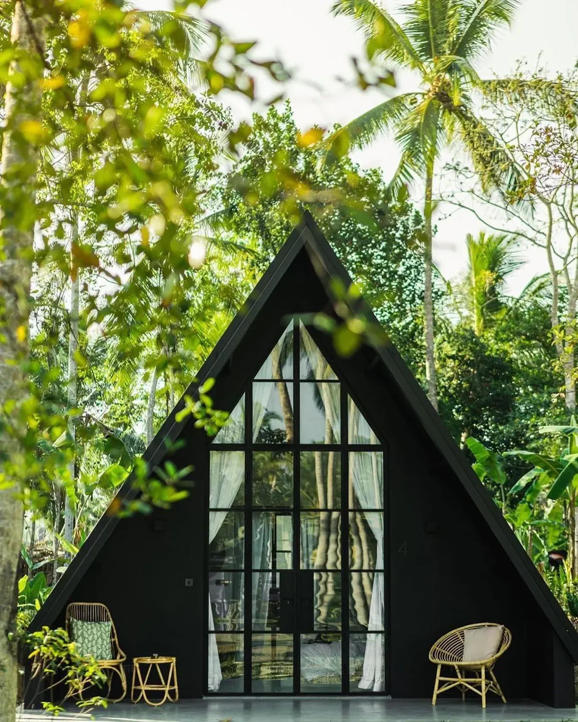 Mistral restaurant in Lake Como: stylish A-frame facade with lush tropical setting