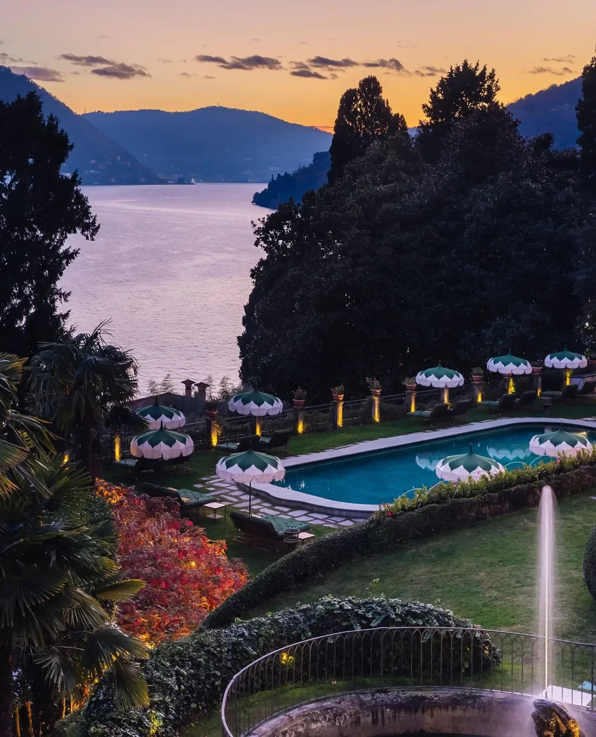 Passalacqua restaurant, Lake Como, at dusk, with pool, garden, and lake views.